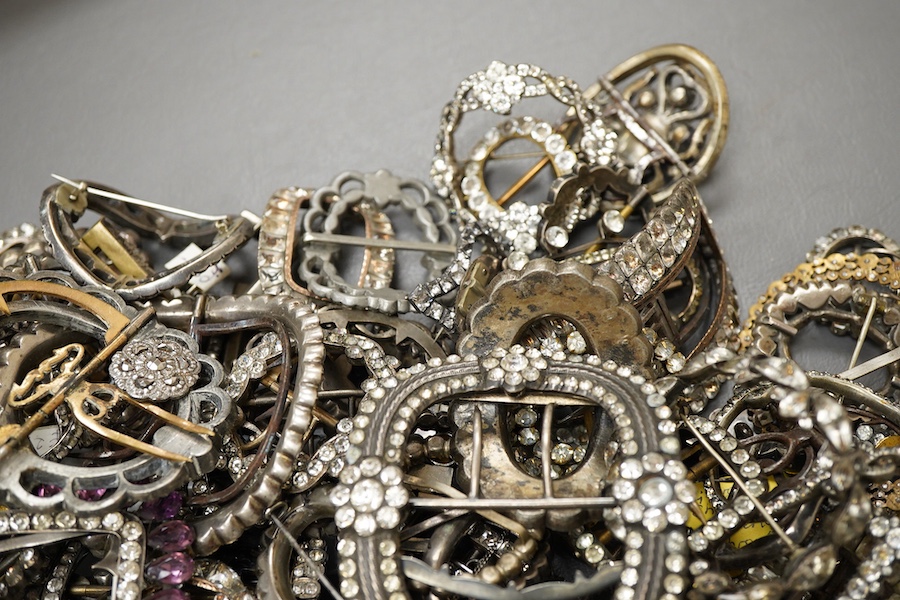 A large collection of buckles, 18th-early 20th century, of oval and rectangular outline, set with pastes, some with cut steel, mostly mounted in steel, a minority in silver, some with later brooch fittings